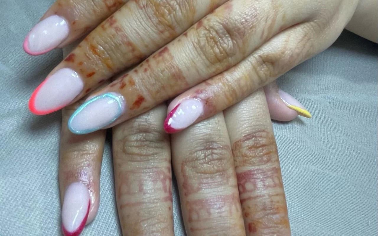 Sheer almond extensions with coloured French tips in red, teal and pink over fresh henna