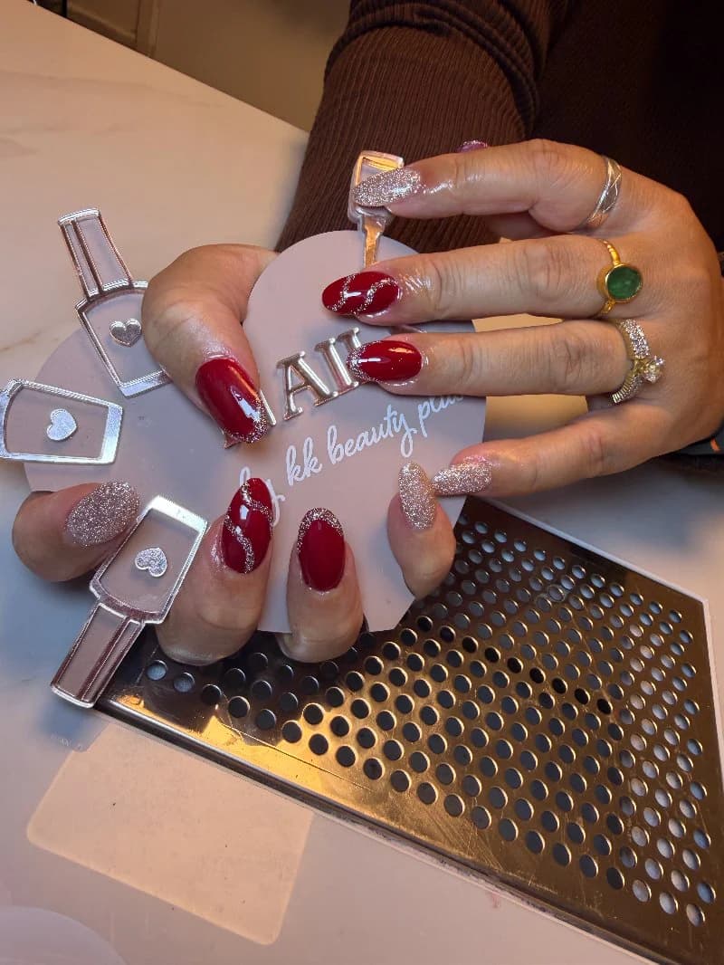 Deep red almond gel nails with rose-gold glitter accent nails