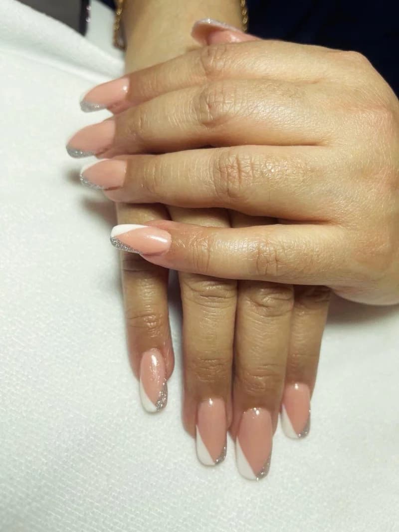 Nude almond nails with a micro French tip and a fine glitter line
