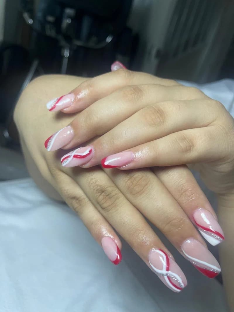 Sheer nude nails with hand-painted red and white line art