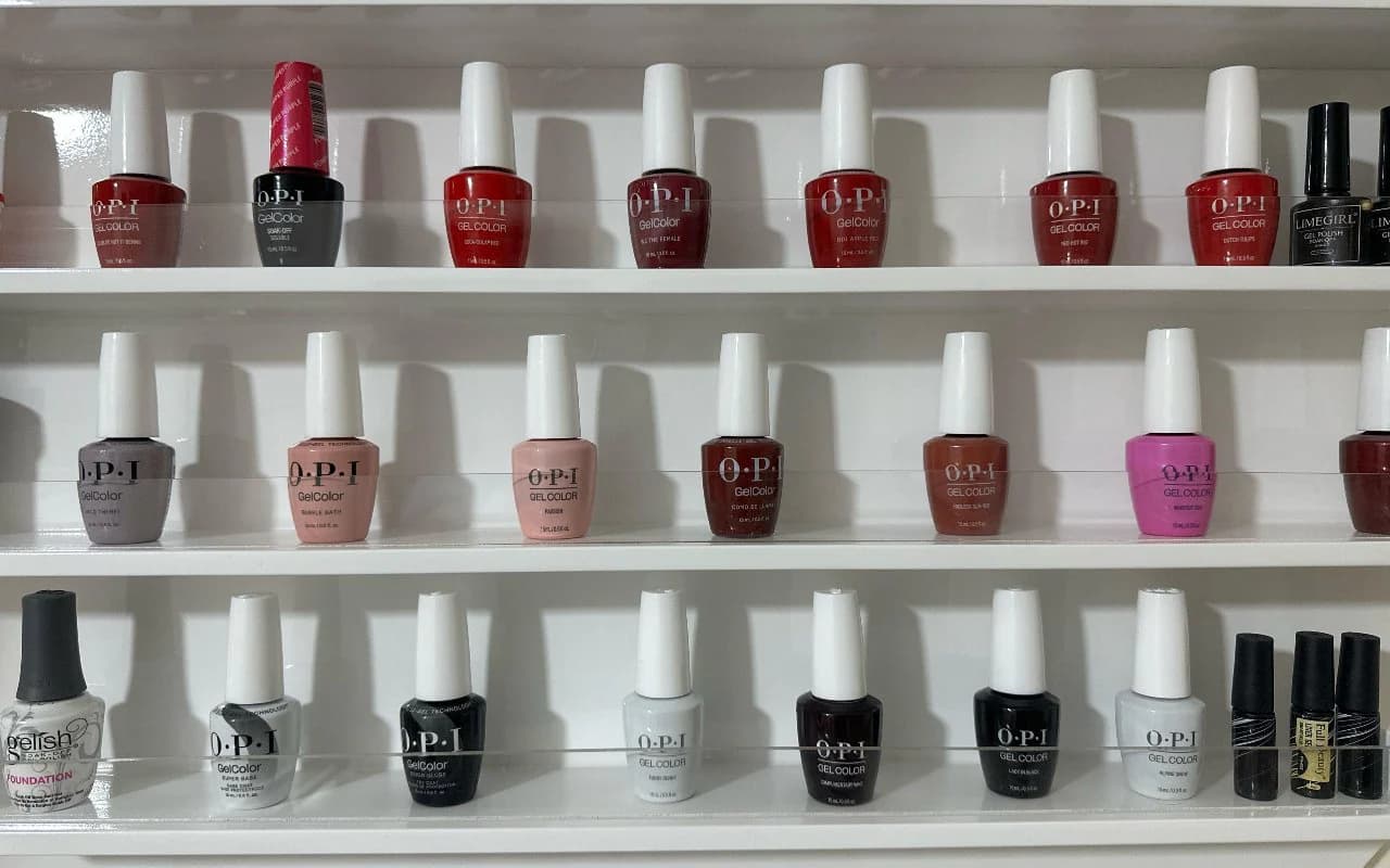 Close-up of the gel colour shelves, from deep reds through nudes to classic white and black