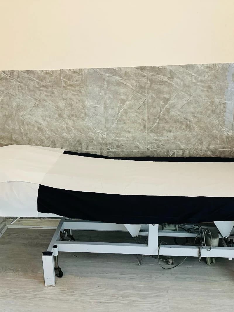 The treatment couch dressed in fresh black and white linen